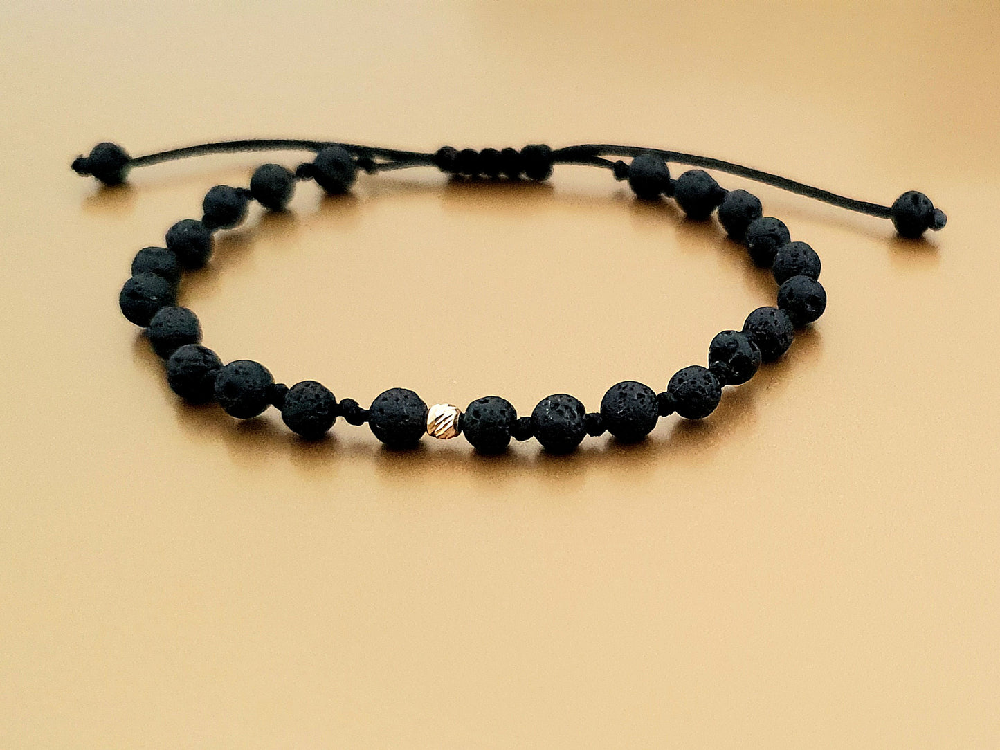 Apyrankės iš aukso karoliukų ir natūraliais lavos akmenukais